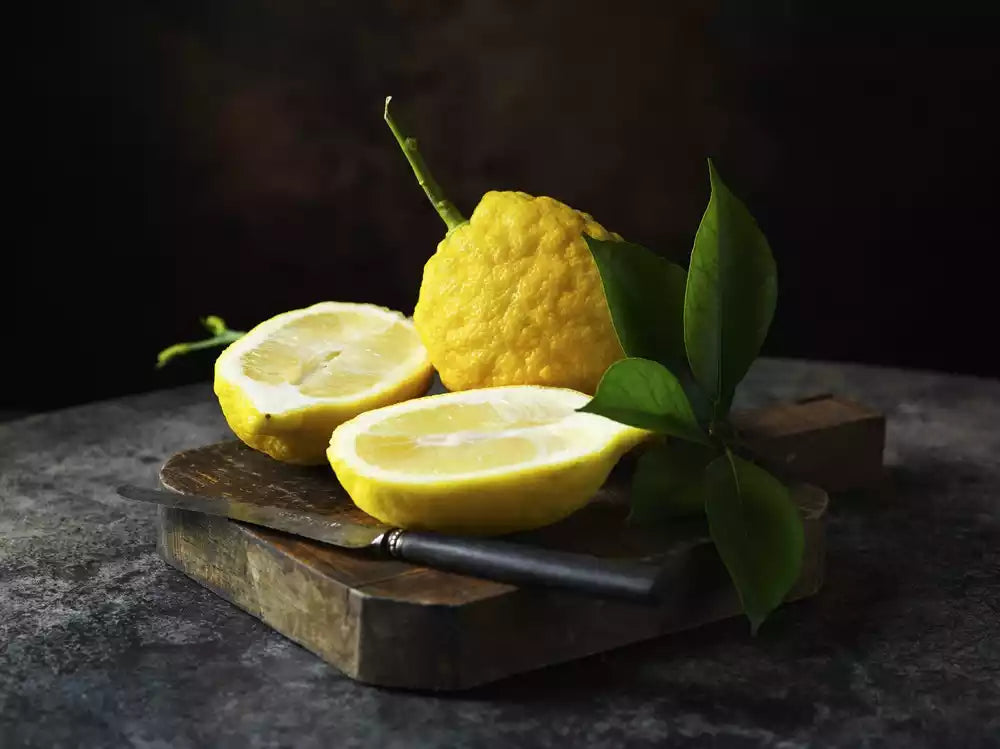 lemon whole and halved with leaves